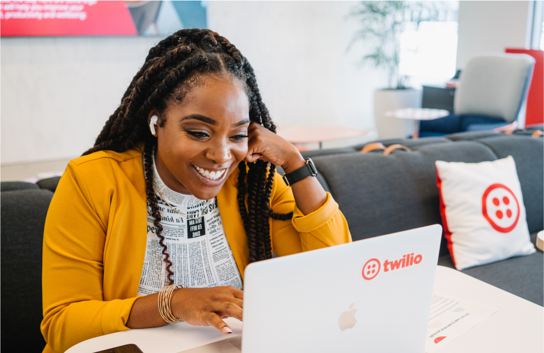 Woman happily looking at laptop screen