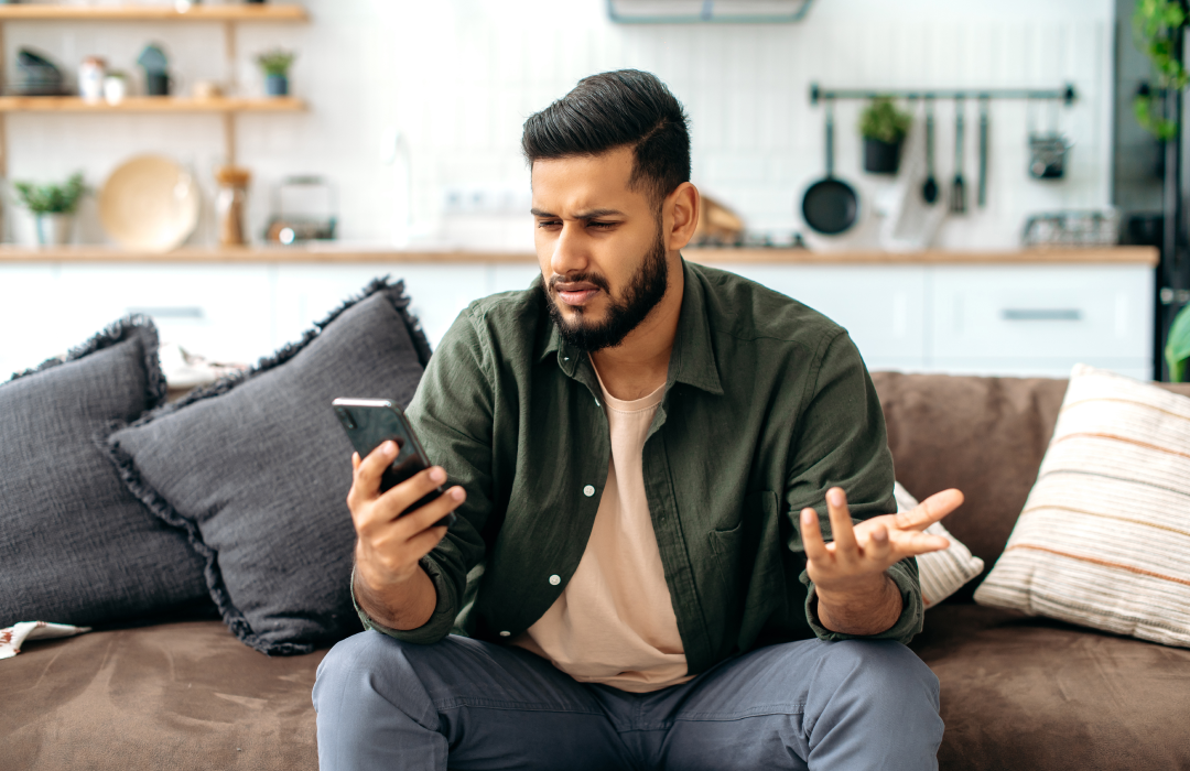 Man looking confused at his phone