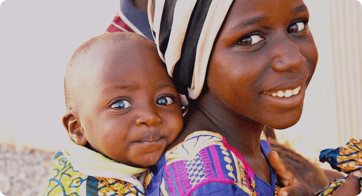 Woman carrying a baby